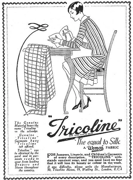 Advert for Tricoline artificial silk fabric, with illustration of a young woman studying a dress pattern with her fabric laid out ready for cutting. Date: 1920s
