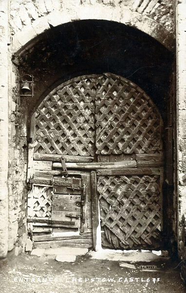The fabulous gateway entrance to Chepstow Castle, Wales - lattice-work doors showing the repairs of age... Date: circa 1906