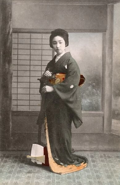 Japanese Geisha standing with her Traditional Shamisen