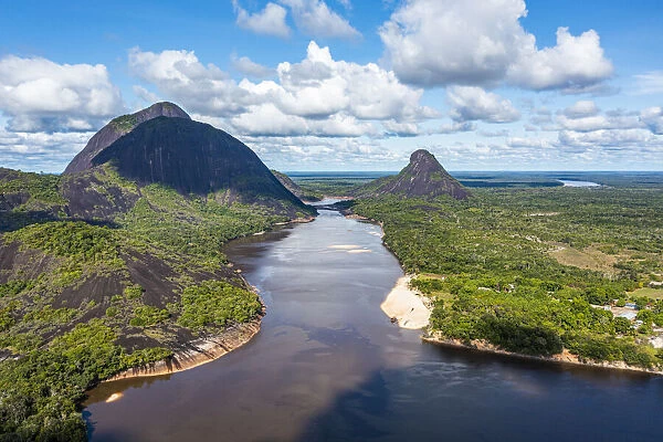 Black river and white sand beach in front of granite hills, Cerros de Mavecure, Eastern Colombia, South America