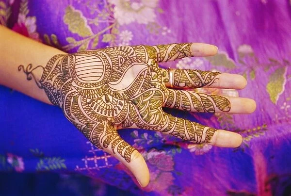 Womans hand decorated with henna