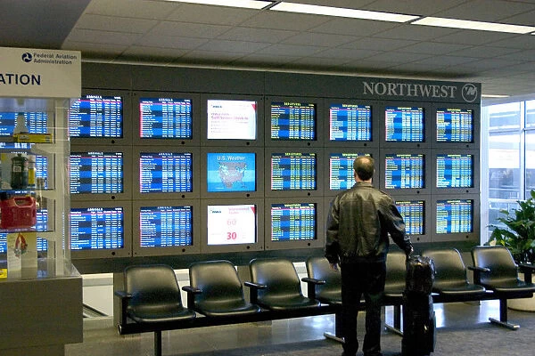 20061825. USA Minnesota Minneapolis Traveller checking Northwest Airlines departure