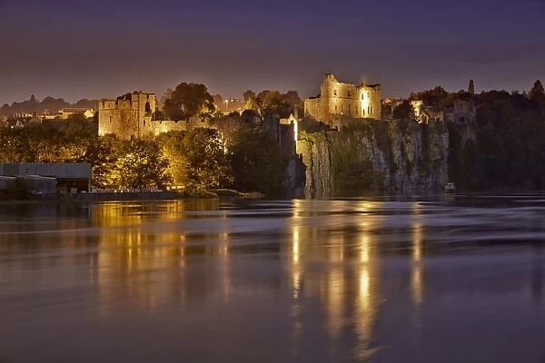 View of castle on cliff overlooking river at twilight, Chepstow Castle, Chepstow, River Wye, Wye Valley, Monmouthshire