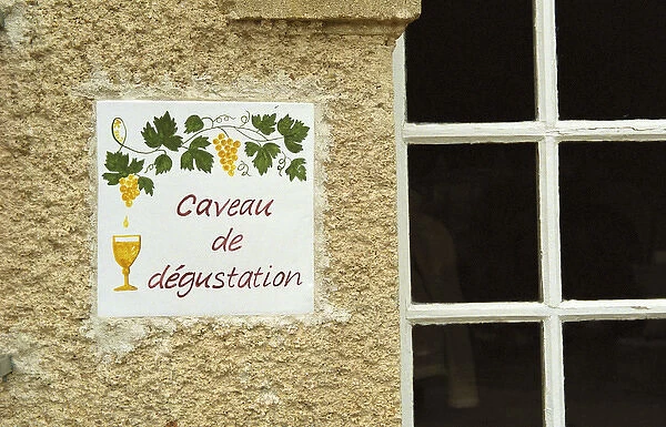 A sign outside the tasting room saying caveau de degustation. Chateau Mourgues du Gres Gres