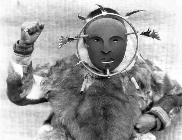 ALASKA: ESKIMO MASK, c1929. A Nunivak native wearing a ceremonial mask, Nunivak Island, Alaska