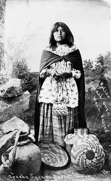 APACHE WOMAN, c1908. An Apache woman posed with willow jugs and woven wash basins. Photograph, c1908
