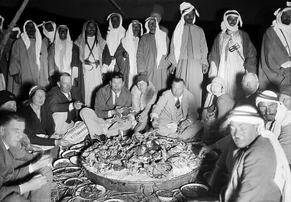 BEDOUIN CAMP, 1931. Several Western couples dining at a Bedouin camp in the Middle East