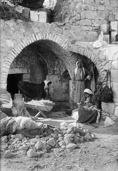 BETHLEHEM: HOME, c1928. A family outside a stone home in Bethlehem. Photograph, c1928