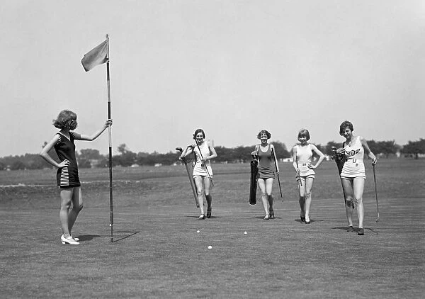 GOLFING, 1926. Women wearing bathing suits on a golf course. Photograph, 1926