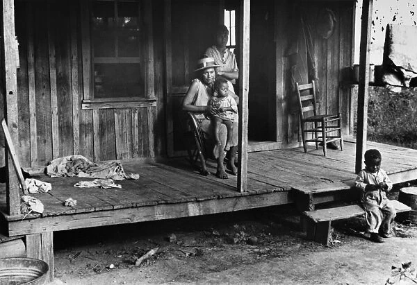 SHARECROPPER FAMILY, 1935. A family of sharecroppers outside their home in Little Rock, Arkansas