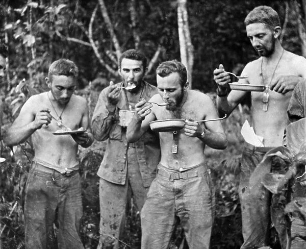 WWII: TROOPS, c1943. American troops eating, probably somewhere in the Philippines