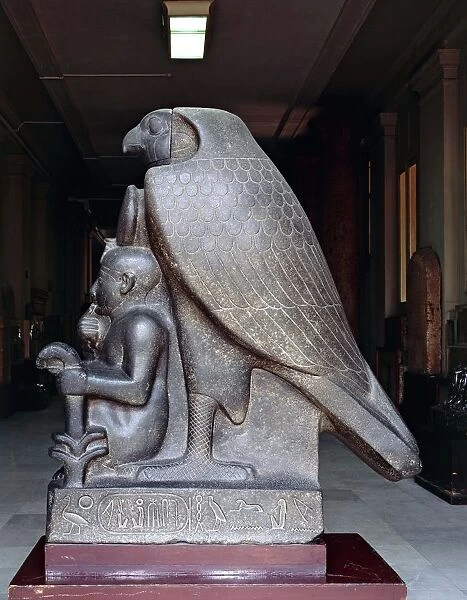 Colossal statue of Ramses II as a child with god Horus, made of granitoid rock and limestone from New Kingdom