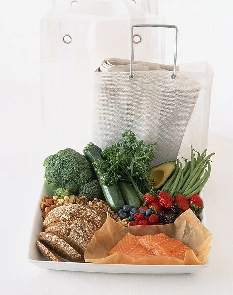 Fruit, vegetables, whole wheat bread, nuts, and newspaper in shopping bag