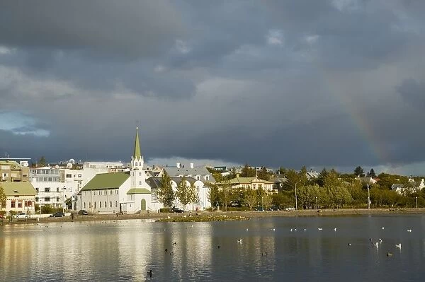 Iceland, Reykjavik, rainbow over Tjornin Lake