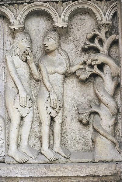 Italy, Emilia Romagna Region, Modena, marble bas-relief depicting temptation of Adam and Eve on Cathedral facade
