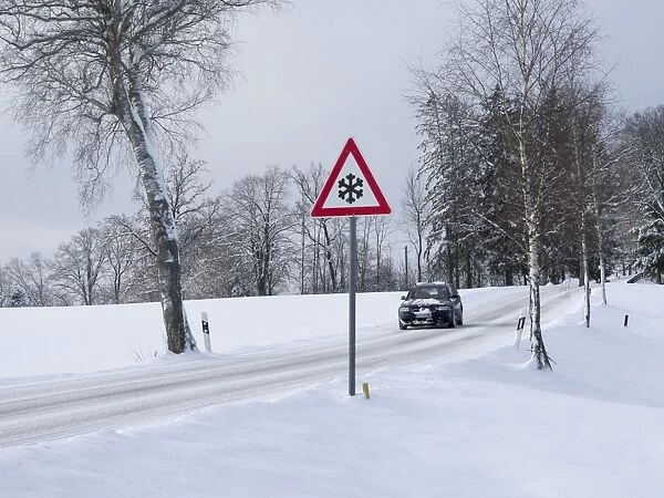 Traffic sign at a snow-covered road in winter, Upper Bavaria, Bavaria, Germany