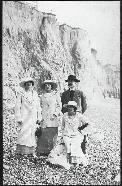 Aault Onival: a family laying on pebbles at the foot of the cliffs of Onival, 1910