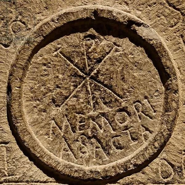 Detail from an altar stone depicting an abbreviation for the name of Jesus Christ