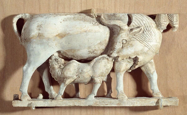 Ancient Oriental Art: ivory cow nursing her calf. Low relief, ivory, around 750