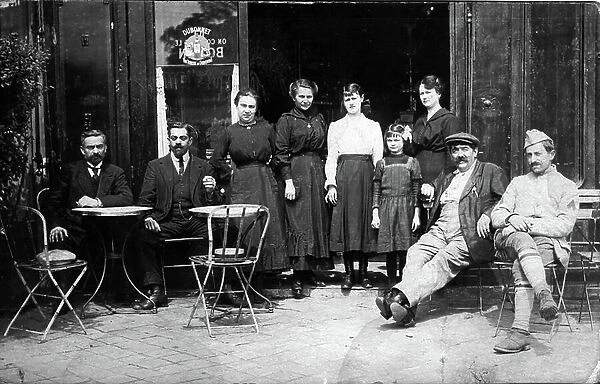 A bar terrace of a cafe with its owners, Paris, 1920 (b / w photo)