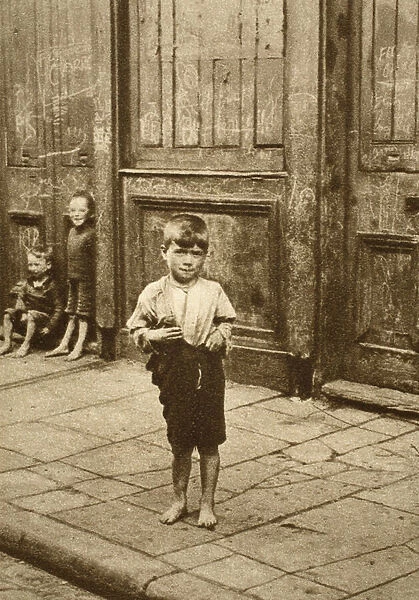Barefoot child on a London street (sepia photo)
