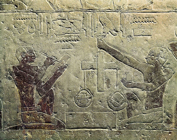 Bas relief representing a merchant and a customer: one of the figures uses a scale while