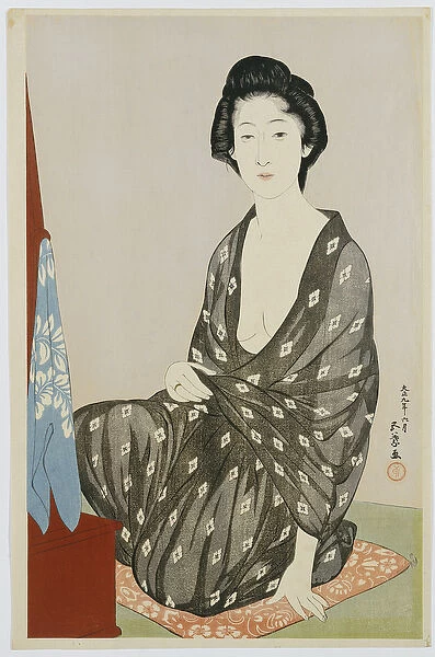 A beauty in a black kimono with white hanabishi patterns, seated before a mirror, 1920 (colour woodblock print)