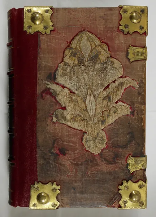 Framed Print : The binding is dated post-1600. Rebound in 1912 reusing embroidered boards with gilt metalwork bosses and fittings for clasps of c. 1553-1558; gilt edges