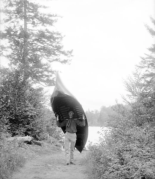 Carrying canoe in the Adirondack Mountains, 1902 (b  /  w photo)