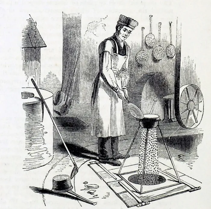 Framed Print : The casting of lead shots