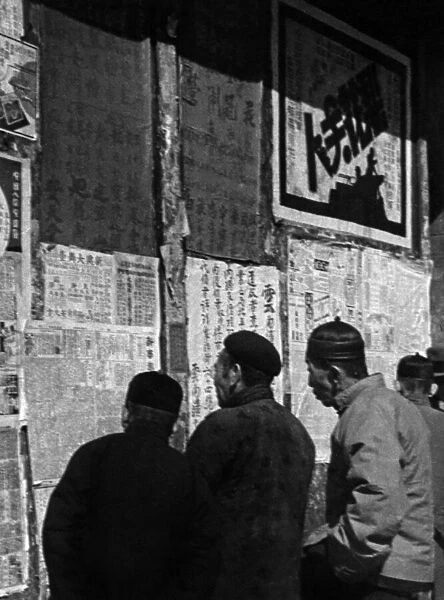 Chinese people reading news of the war on a notice board, Yunnan-Fu, c. 1946 (b  /  w photo)