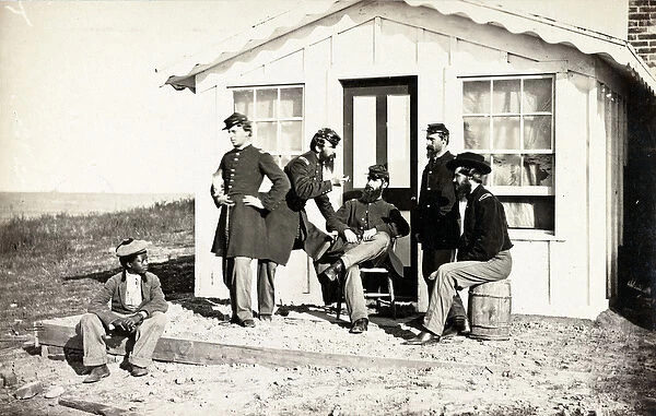 Five Civil War soldiers gathered on dirt porch outside home, African American youth