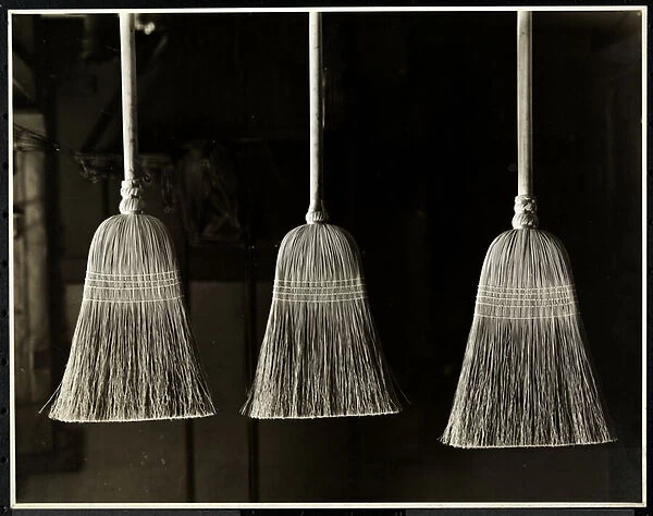 Closeup view of three brooms, presumably made by the men of the Bourne memorial Building