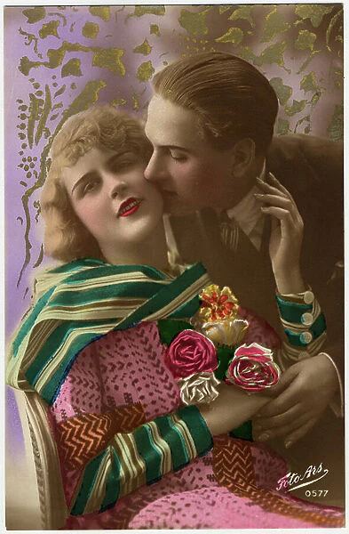 A couple of lovers kissed, the young woman holds in hand a bouquet Postcard from 1900-1930