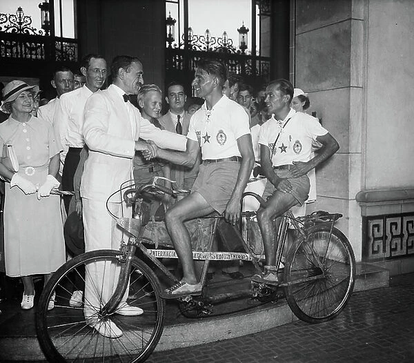 Dr. Rowe of Pan-American Union greets Argentinian cyclists after a two-and-a-half-year journey, 1936 (b / w photo)