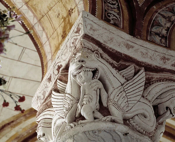 A dragon eating a man, carved capital of the chancel