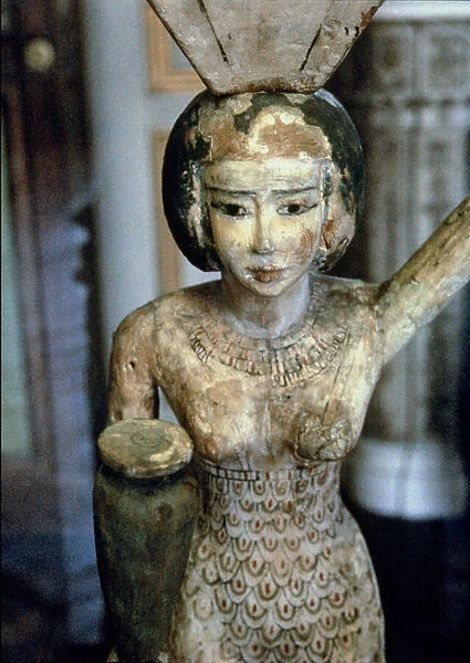 Female bearer of offerings carrying a water vase in her hand and a vessel on her head, Egyptian, Middle Kingdom, c. 1950 BC (stuccoed and painted fig wood) (detail of 93791)