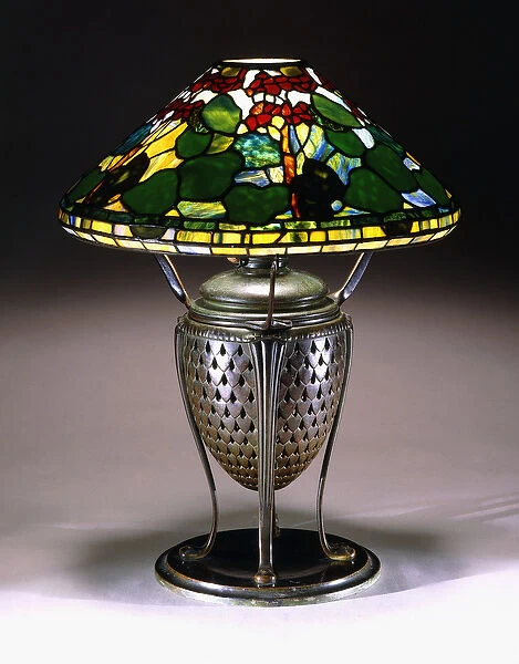 A Geranium table lamp with a conical shade, and reticulated bronze urn base