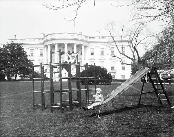 Grandchildren of President and Mrs Franklin D. Roosevelt, Little Sistie and Buzzie Dall, at play on the White House grounds, 1933