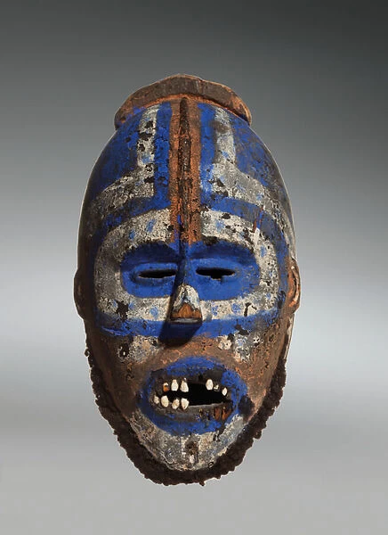 A Grebo Mask, from Maryland County, Area of Nyaake, Liberia (wood with pigment, human teeth & hair)