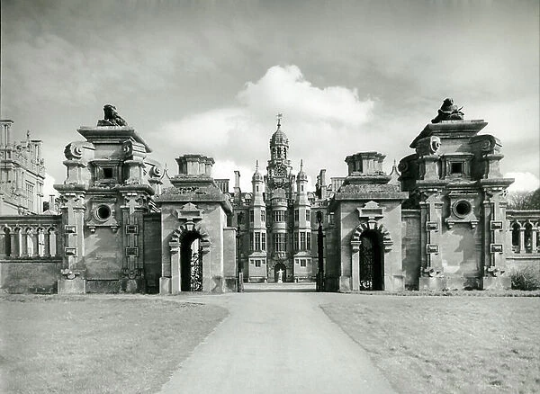 Harlaxton Manor, view of the front entrance through the forecourt screen, from 100 Favourite Houses (b / w photo)