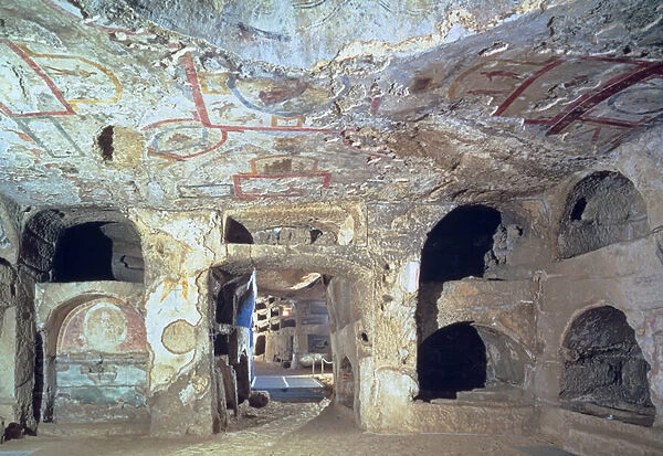 Interior of a catacomb chamber cut from tufa stone showing fragments of frescoed