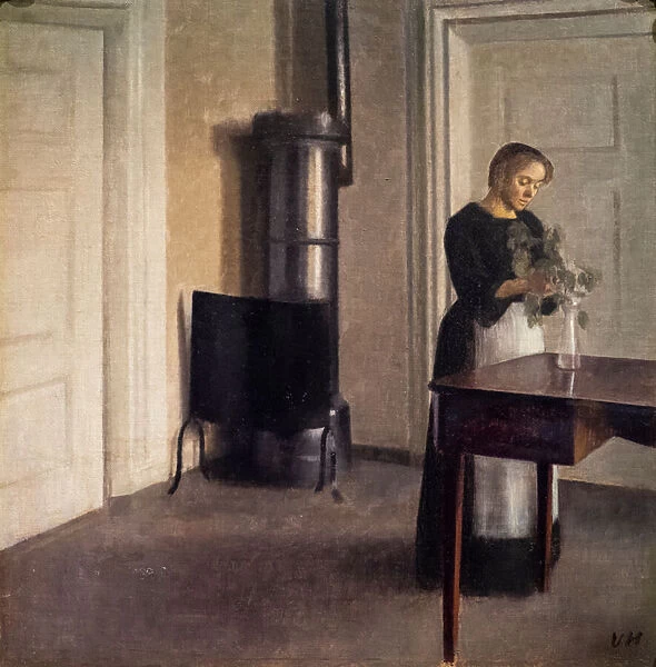 Interior with a woman arranging flowers in a vase, 1900 (oil on canvas)
