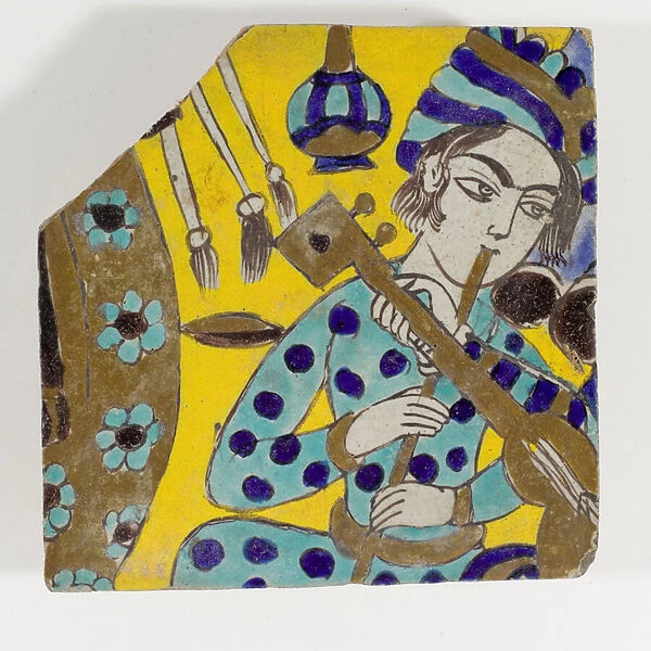 A late 17th century Safavid Persia cuerda seca pottery tile depicting a man playing a