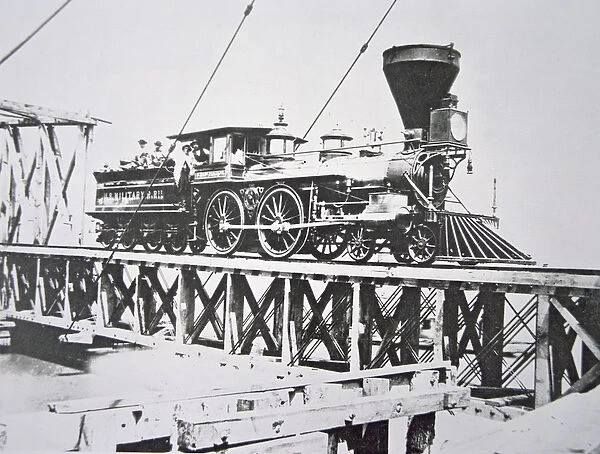 Locomotive of the US Military Railroads (Union Army) crossing trestle bridge over