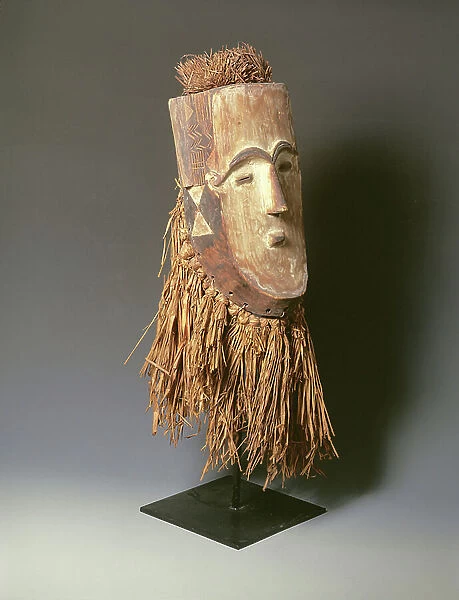 Mask with incised zig-zag and striated patterns and an attached beard and headpiece from the Masango tribe of the Gabon, Africa (wood & raffia)