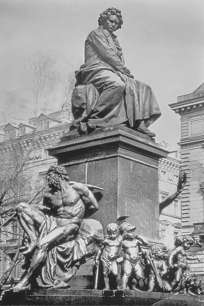 Monument to Ludwig van Beethoven, the composer seated on a pedestal above figures
