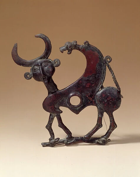 Oriental Antiquities: bronze jaw plate depicting an androcephalous monster trampling a