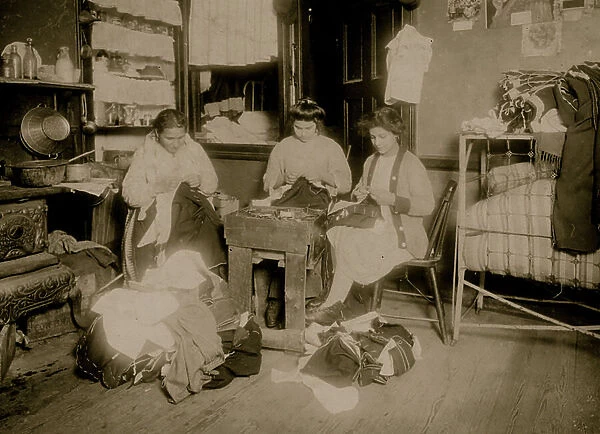 The Pallagi Family sewing trousers, 1912 (b / w photo)