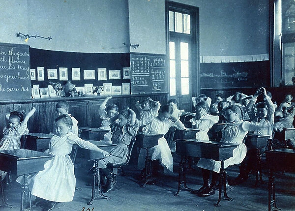 Photographic print, Cyanotype : Children doing calisthenics while sitting at their desks in a classroom, 5th Division public schools, Washington, D. C
